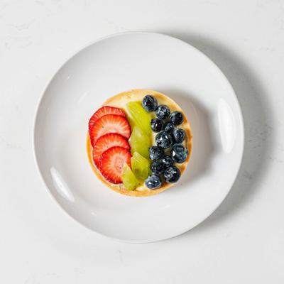 Fruit tart, with strawberries, blueberries, and kiwi.