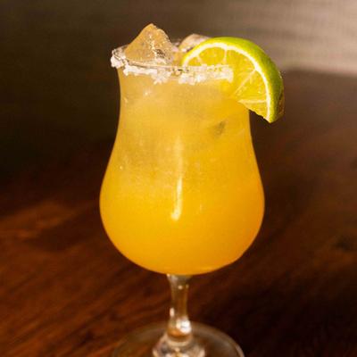 Peach Margarita with lime wedge.