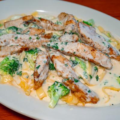 Fettuccine Alfredo with grilled chicken and broccoli.