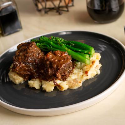 Braised Short Ribs served over potato puree and broccolini.