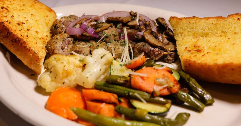 Mushrooms with onion, cauliflower, carrot, zucchini and peas served with toast
