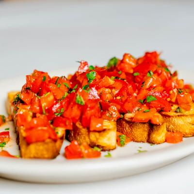 Bruschetta, topped with fresh tomato, basil and garlic.