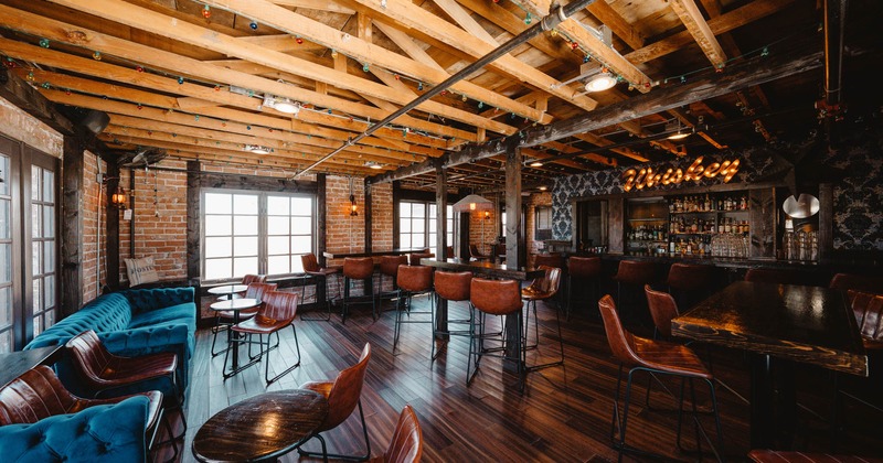 Inside, buttoned sofa, tables, chairs, bar