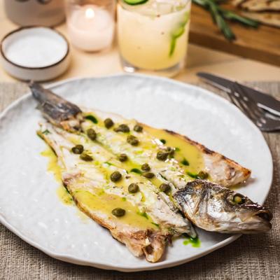 Grilled Mediterranean sea bass, in sauce, with horta greens.