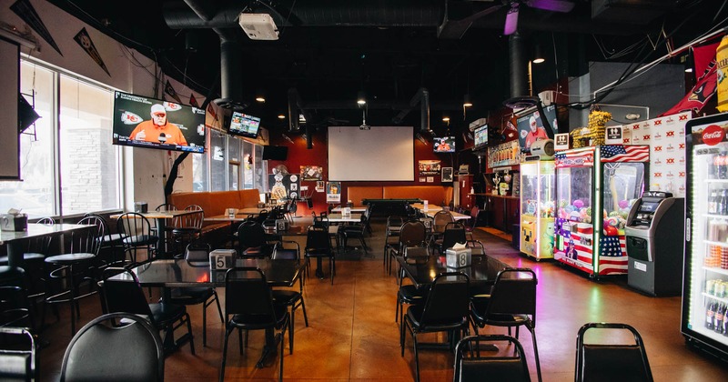 Interior, seating area, TVs, claw machines