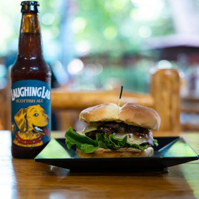The Mushroom  Swiss Bison Burger paired with a bottle of beer.