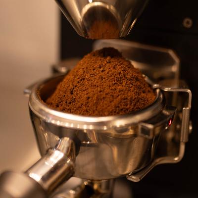 Portafilter filled with espresso coffee, close up.