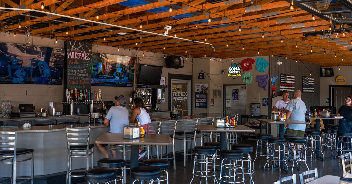 Interior, bar and seating space with bar stools and tables