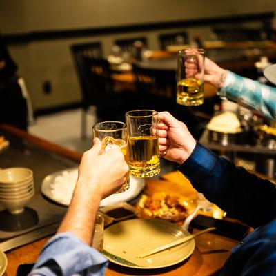 A group of guests toasting with drinks at a table.
