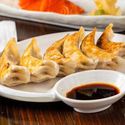 Homemade gyoza served with soy sauce for dipping.