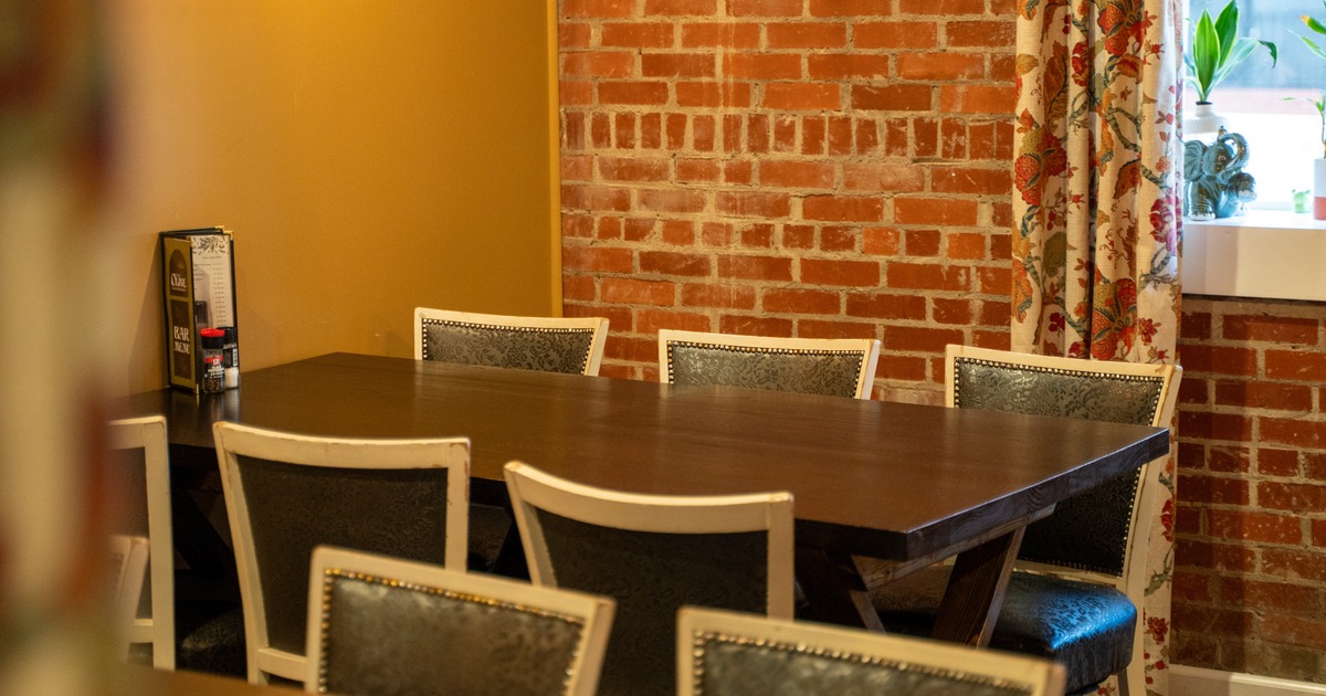 Interior, dining area with yellow and brick walls