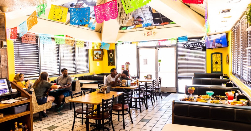 Interior, tables, chairs and sitting booths, guests enjoying their food