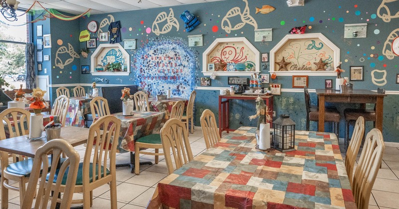 Diner tables and chairs, decorated wall behind