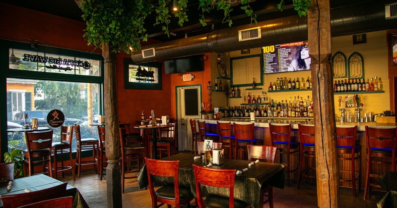 Interior, dining space with a bar behind