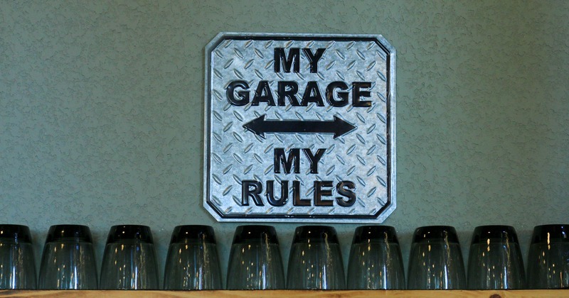 A metal sign reading My Garage My Rules