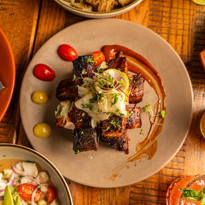 Assorted dishes with rib plate as the centerpiece, top view.