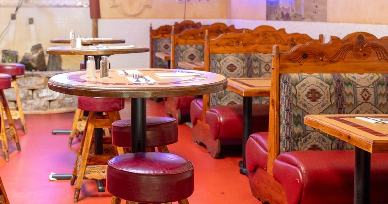 Interior seating area with double booths and bar stools
