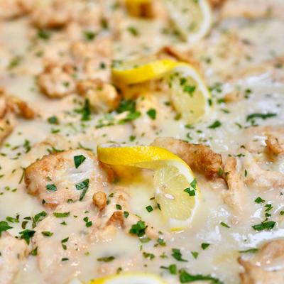 Creamy lemon chicken pasta, close up.