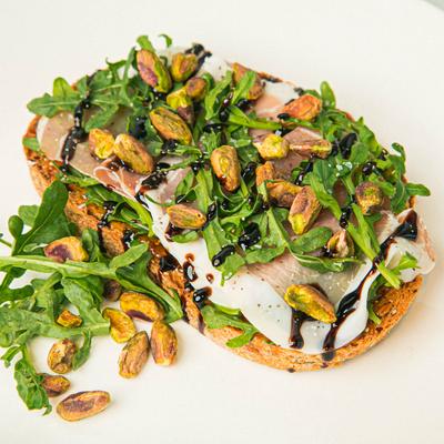 Toast with prosciutto, arugula, pistachios, and balsamic.