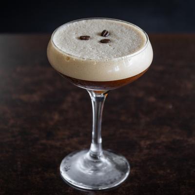 Espresso Martini garnished with three coffee beans.