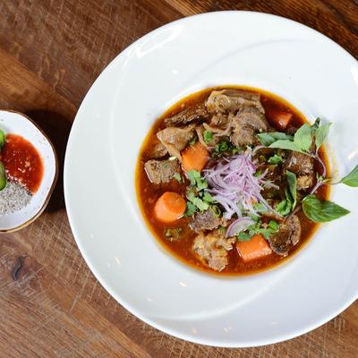 Beef stew with condiments on the side.