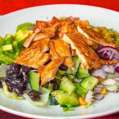 Chopped salad with grilled chicken, black beans, peppers, and onions.