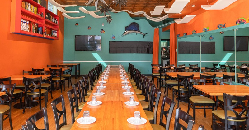 Interior, dining area, long wooden top table setup, tables for four, TV on the wall