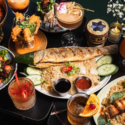 Various dishes and cocktail on a table.