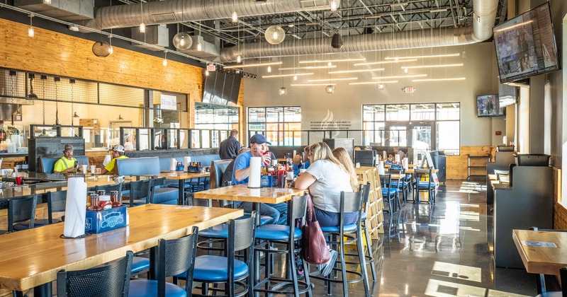 Interior, high tables and chairs, guests sitting and chatting