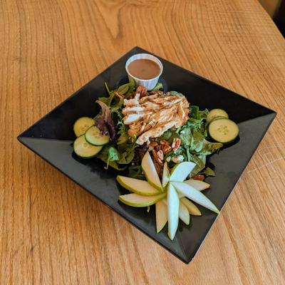 Grilled chicken salad cucumbers, pecans, sliced green apple and a side of dressing.