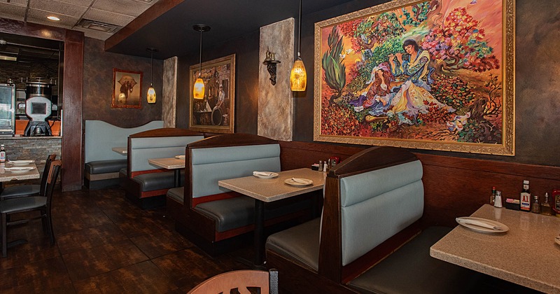 Interior, tables and sitting booths, pictures on the wall