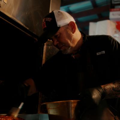 Chef cooking barbecue in the kitchen.