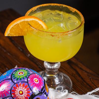 Mango Margarita with orange slice garnish.