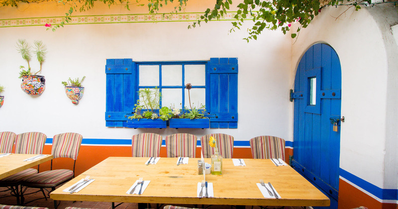 Exterior, village style design of patio with  seating and tables