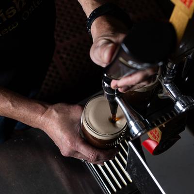 Staff member pouring beer