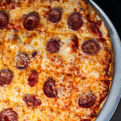 Cheese pizza with smoked beef sausage, top view.