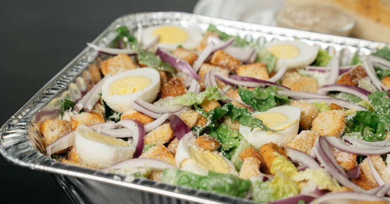 Caesar Salad, with lettuce, garlic croutons, Romano cheese, and hard boiled eggs