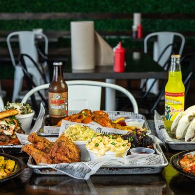 Assorted dishes and drinks spread on a table in dining area.