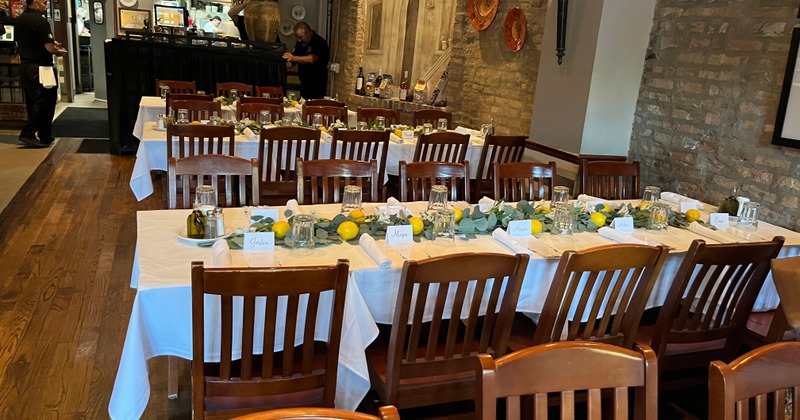 Interior, long tables arranged and set for a banquet event