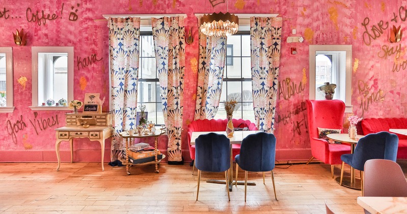 Interior, lounge area, coffee tables with armchairs and sofas, graffiti tags on the wall