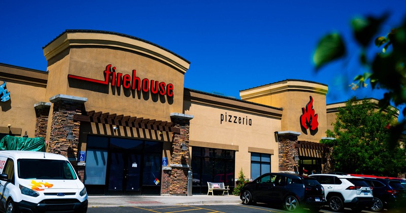 Firehouse Pizzeria building and parking lot on a sunny day