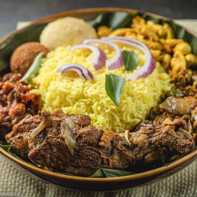 A dish of meat , rice ,cashews, and vegetables