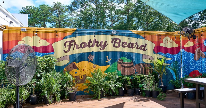 Exterior, covered patio with bench, table and fan