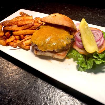Cheeseburger topped with melted cheddar, served with fries, lettuce, tomato, onion, and pickles.