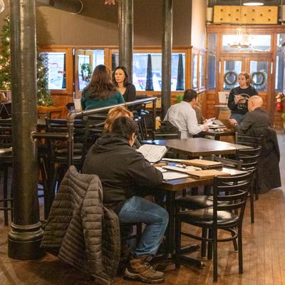 Interior, seating area, patrons sitting at tables.