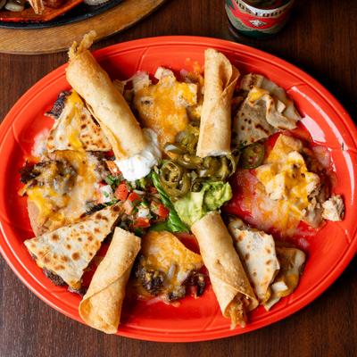Bonata plate with beef nachos, chicken flauta and cheese quesadillas.