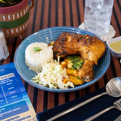 Chicken dish, with potato, chimichurri, Peruvian giant corn, white rice, and slaw.