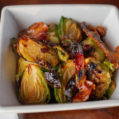 Maple Bacon Brussels Sprouts served in a deep white dish.