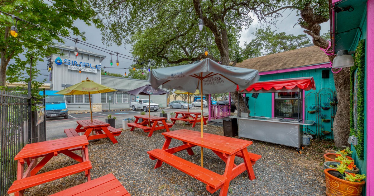 Exterior, seating area, wooden picnic tables and parasols