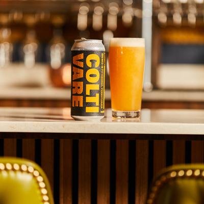 Craft beer can and a glass of beer on a counter.